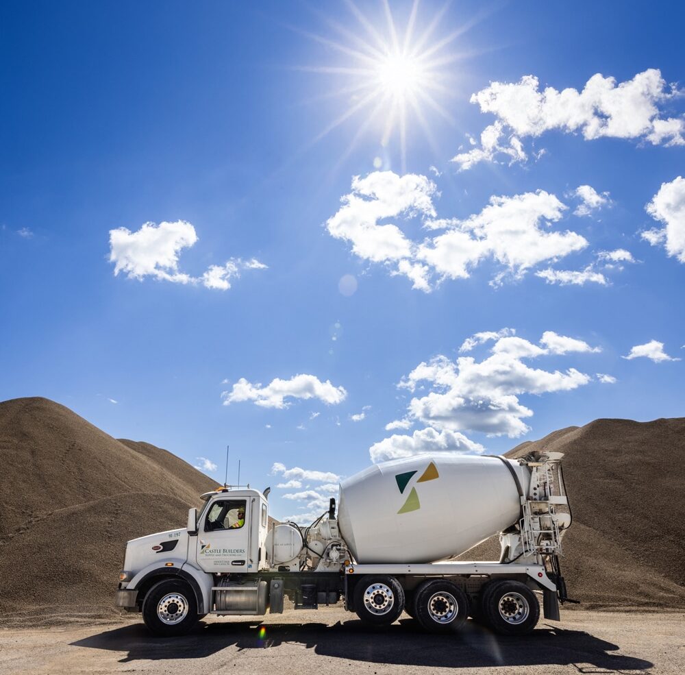 CBS truck parked in front of mounds of mix at plant site